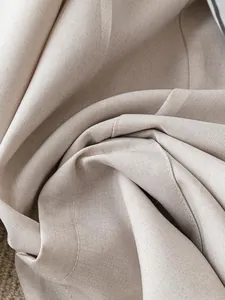 Close-up of beige British style blazer fabric showing high-quality linen-like texture