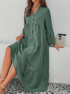 Elegant forest style green V-neck tiered midi dress with bell sleeves and button details