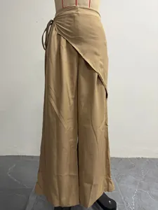 Close-up detail of khaki irregular high-waist wrap-around wide-leg suit trousers for women