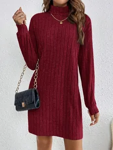 Close-up detail of a burgundy ribbed knit turtleneck dress with elegant long sleeves