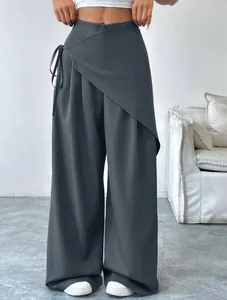 Detailed view of women's irregular high-waist wide-leg suit trousers in dark grey