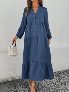 Detailed view of the elegant blue V-neck tiered long-sleeved A-line dress with texture