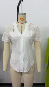 Detail view of the white blouse with lace short sleeves and hollow embroidered shoulders