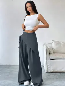 Full-length view of a model wearing grey irregular wrap wide-leg suit trousers