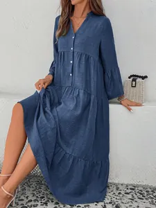 Close-up of blue V-neck tiered midi dress with button details and ruffled sleeves