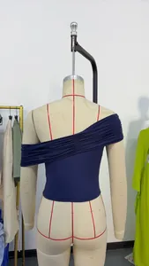 Back view of navy blue pleated one-shoulder top on a mannequin showing design details