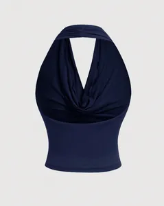 Detailed view of the draped halter neck and backless design of this navy blue top