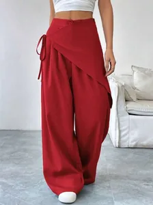 Elegant red asymmetrical wrap wide-leg trousers featuring a stylish waist tie detail.
