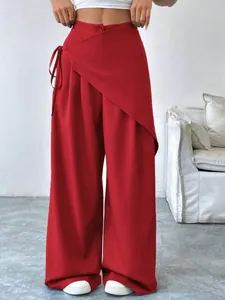 High-waisted red wide-leg suit pants with unique asymmetrical wrap-front design detail.