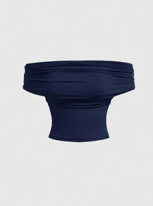 Detail of a navy blue pleated off-the-shoulder top with a layered fabric texture