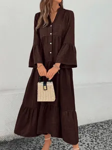 Elegant woman wearing brown Mori style V-neck tiered midi dress with ruffle bell sleeves