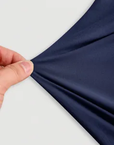 Close-up of stretchy dark navy fabric showing high elasticity and soft texture