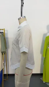 Side view of women's striped polo shirt with contrast white collar and cuffs