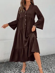 Close-up of a dark brown tiered V-neck midi dress with flared bell sleeves and button details.