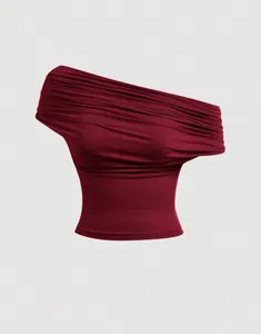 Close-up of the elegant ruched detailing on a burgundy off-the-shoulder multi-way top.