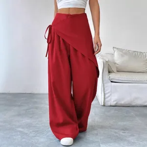 Elegant red asymmetrical wide-leg trousers with high waist and side tie detail for women