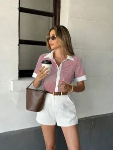 Detailed view of women's red and white striped polo shirt with white contrast collar