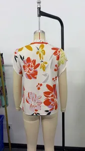Detailed back view of a white floral print short sleeve blouse displayed on a dress form