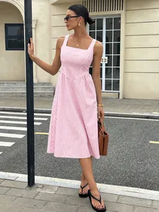 French style pink and white striped midi dress with square neck in urban street setting.