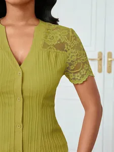 Close-up of olive green slim fit V-neck blouse with intricate lace shoulder detail