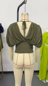 Detailed back view of an olive green V-neck short sleeve top with a smocked waist design