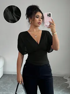 Detailed view of a black deep V-neck waist-cinching top with butterfly sleeves texture