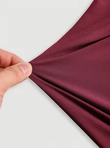 Close-up of the stretchy burgundy fabric for this versatile halter top showing elasticity