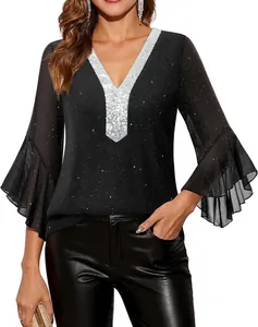 Close-up of elegant black sequin top with silver V-neck and ruffled mesh sleeves
