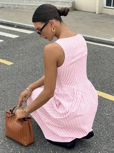 Side view of a French pink and white striped sleeveless long dress with a cinched waist
