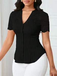 Detail view of a black slim fit top featuring lace embroidery and a button-up V-neck design.