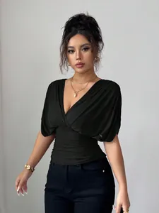 Detail view of black deep V-neck top with stylish fly sleeves and cinched waist