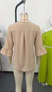 Detailed back view of a beige loose blouse featuring ruffled mid-sleeves and back pleat