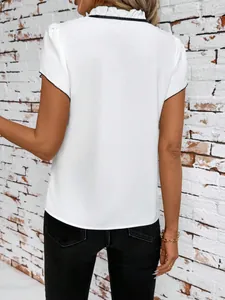 Back view of a chic white short sleeve blouse with ruffled collar and black contrast piping detail