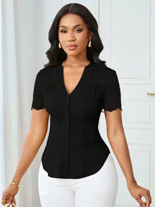 Detailed view of a black slim-fit button-down top with elegant lace embroidery sleeves.