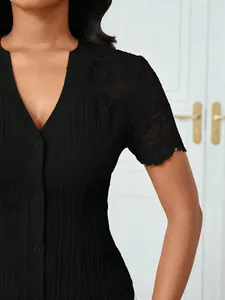 Detailed view of women's black slim-fit button-down blouse with lace shoulder lace