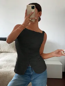 Slim fit black textured button-down sleeveless top for women in a stylish mirror selfie