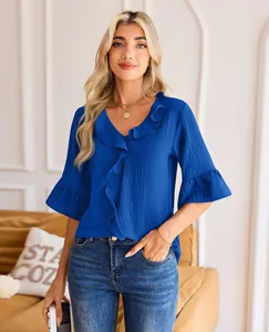 Elegant blue V-neck blouse with ruffle trim and half sleeves in a casual loose fit style