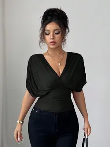 Detailed view of black deep V-neck ruched top with flutter sleeves and slim waist