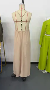 Detailed back view of a beige backless maxi dress with crinkle fabric and bead accents