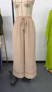 Casual beige high-waisted wide-leg trousers featuring drawstring waist and delicate lace trim