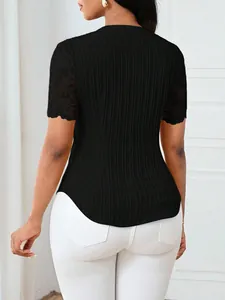 Detailed rear view of a black ribbed knit top with intricate lace short sleeves