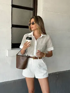 Fashion model wearing a striped short sleeve polo shirt and white shorts in an urban setting