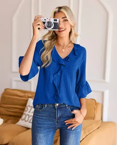 Elegant royal blue V-neck blouse featuring ruffled neckline and bell sleeves detail.