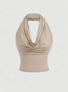 Close-up of a beige cowl neck halter tank top with elegant fabric draping details.