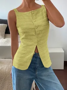 Detail of lime green textured sleeveless top with single-breasted buttons and front slit.