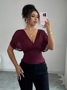 Close-up of elegant burgundy V-neck ruched top featuring a flattering slim waist fit design