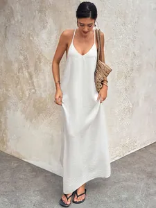 Detailed view of a white crinkle texture maxi dress with deep V-neck and backless design