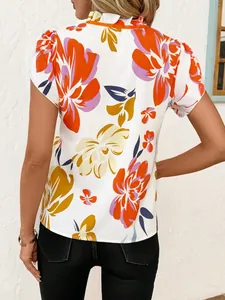 Back view of a women's short-sleeved top with vibrant floral patterns and pleated neck