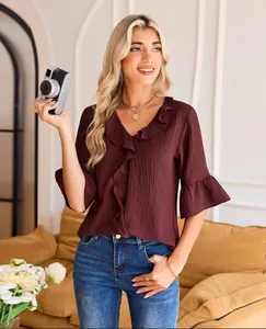 Detailed shot of wine red V-neck blouse with elegant ruffles and flared half sleeves