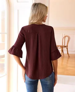 Rear view of a burgundy textured blouse with elegant ruffled sleeves and relaxed fit